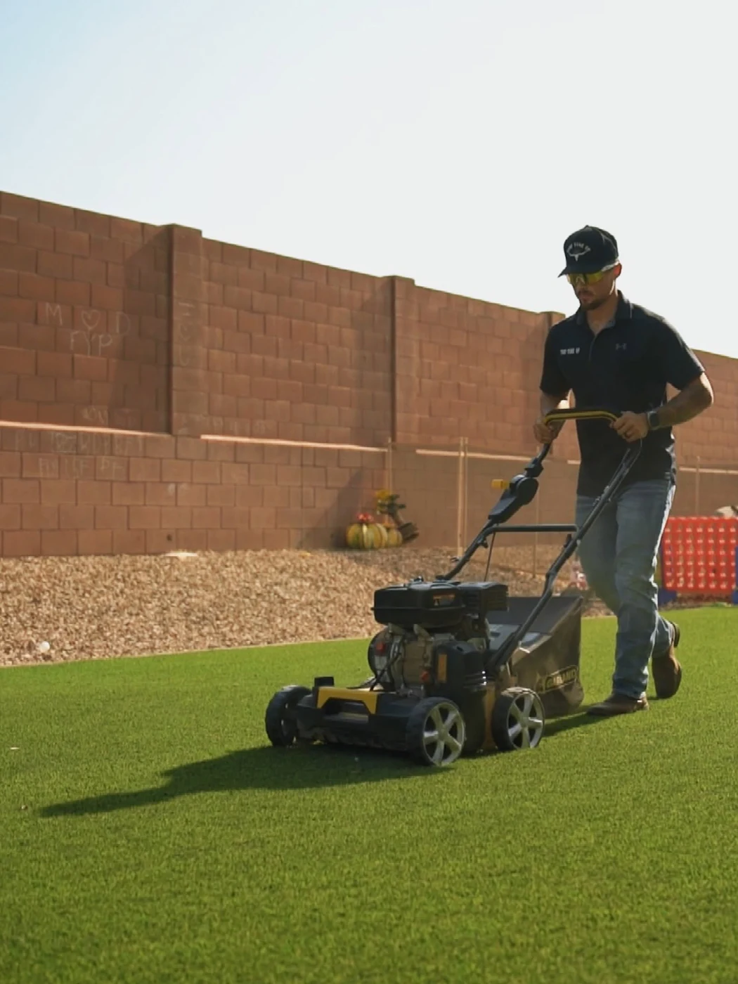 Turf Tune Up technician working on an artificial turf yard
