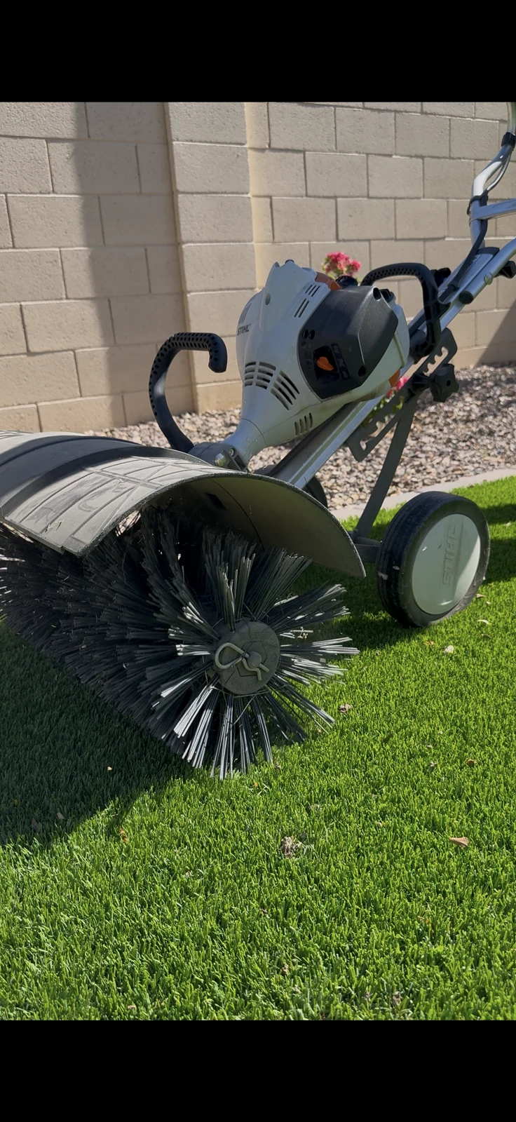 Power broom lifting artificial turf fibers