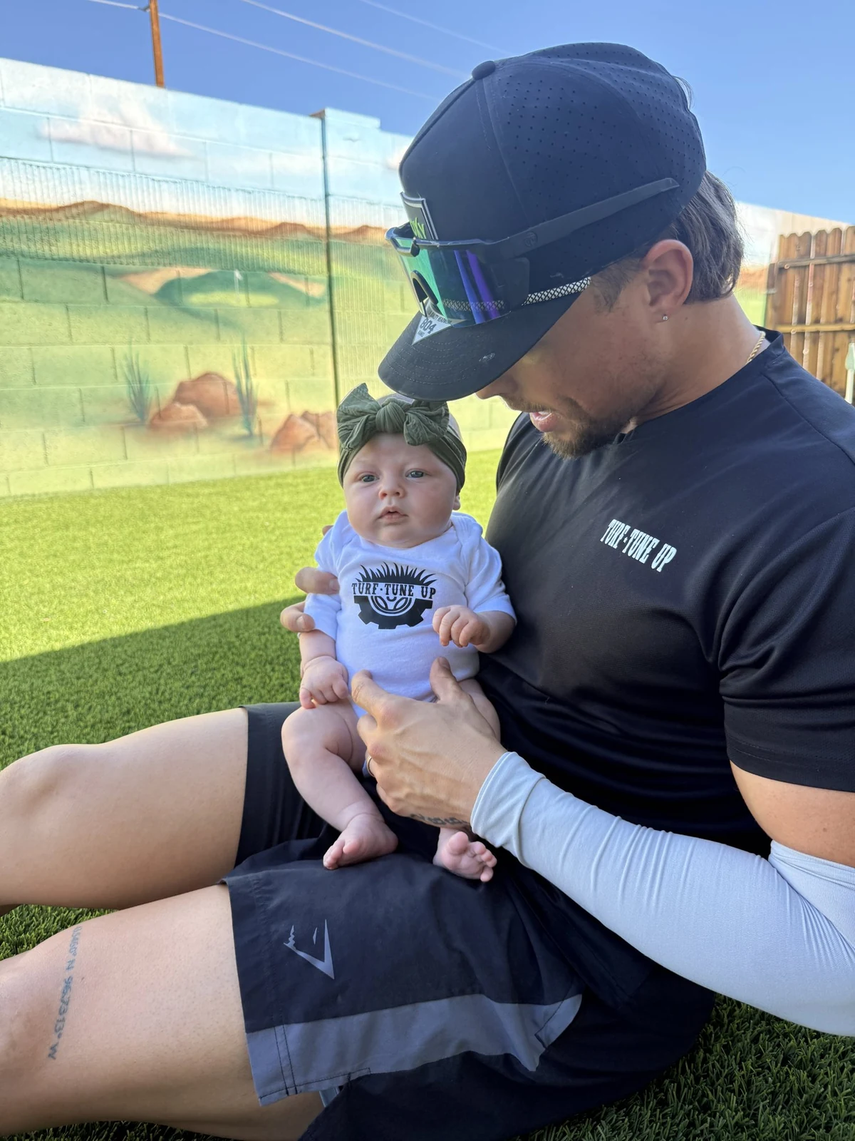 Chase Adams, owner of Turf Tune Up, with his daughter