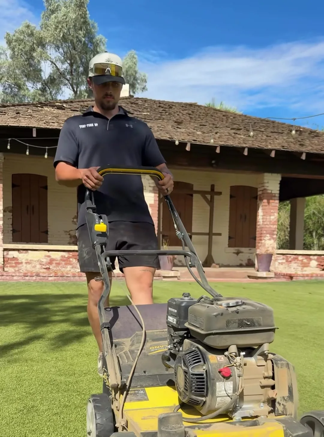 Turf Tune Up technician power brooming an artificial turf lawn
